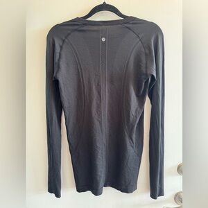 Light pink and black Lululemon activewear long sleeve top
